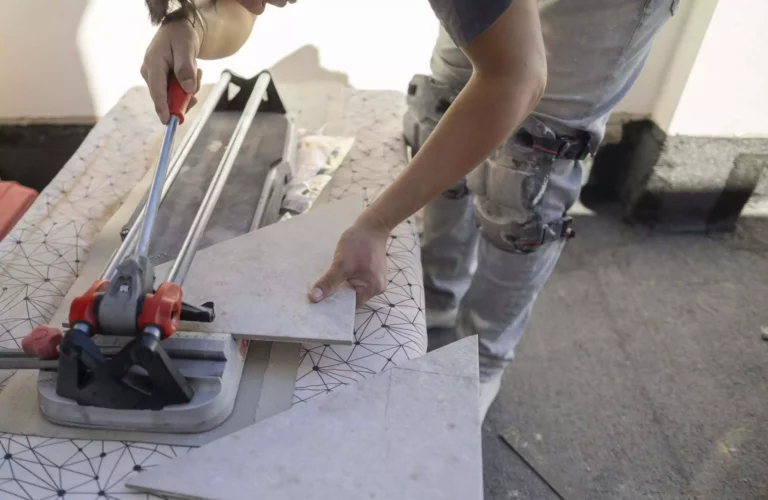 Worker Cutting Tiles To Tile Terrace